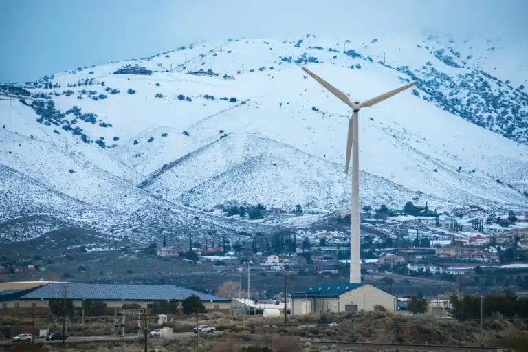Snow-covered hills and wind turbine in Palmdale, California, showcasing the local landscape where small businesses compete and grow.