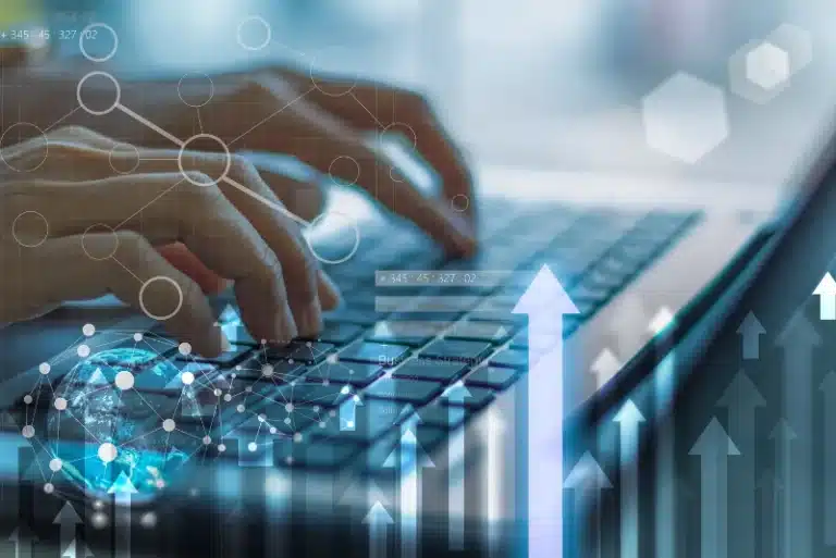 Hands typing on laptop with digital marketing graphics overlay—representing common online marketing myths, SEO misconceptions, and data-driven strategies for LA businesses.