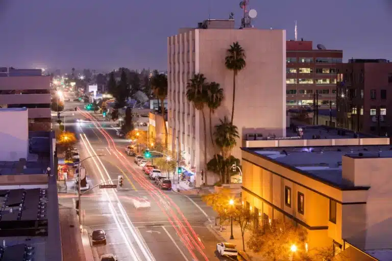 Bakersfield, California city skyline with downtown buildings, palm trees, and the surrounding Kern County landscape under a clear sky