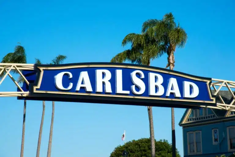 Carlsbad coastal cityscape with ocean views, palm-lined streets, and residential neighborhoods in Southern California.