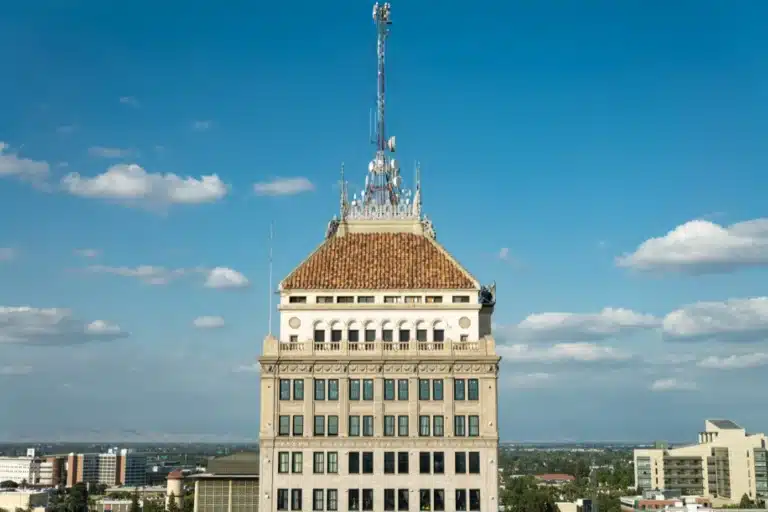 Historic downtown Fresno building under a clear blue sky, symbolizing long-term growth and visibility for Fresno businesses using strategic digital marketing to reach local customers.