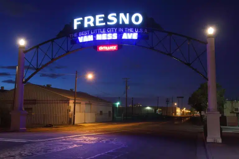 Illuminated Fresno Van Ness Avenue entrance sign at night, representing local identity and opportunity for Fresno businesses investing in digital marketing to stand out in a competitive market.