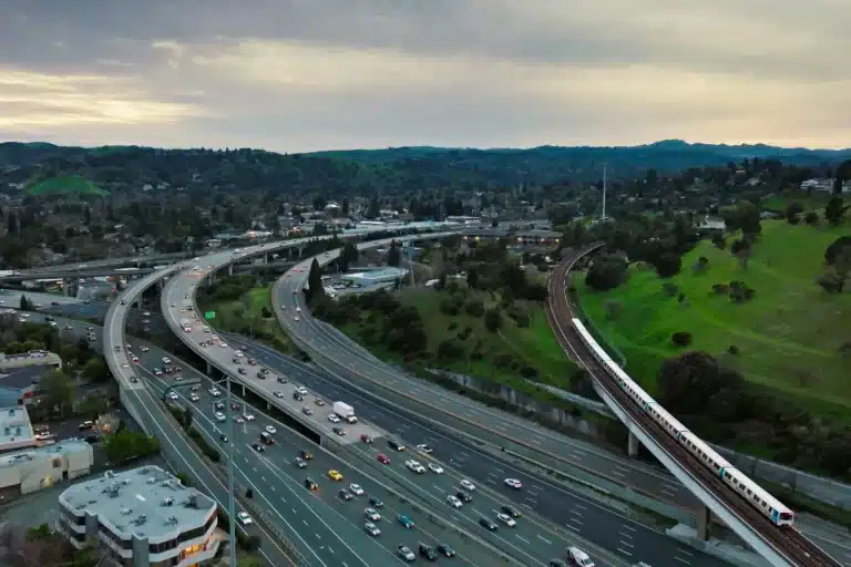 Highway interchange in Walnut Creek, CA with multiple lanes of traffic and surrounding greenery.