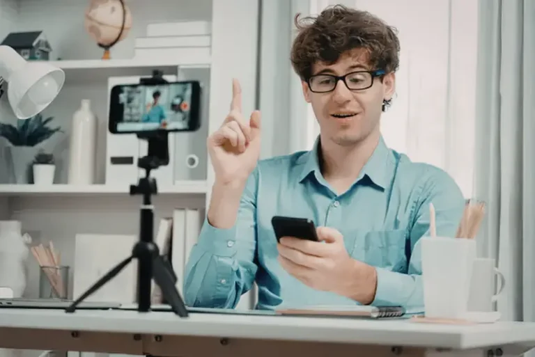 Small business owner sitting at a desk with laptop open to social media dashboard, appearing stressed by low ROI.