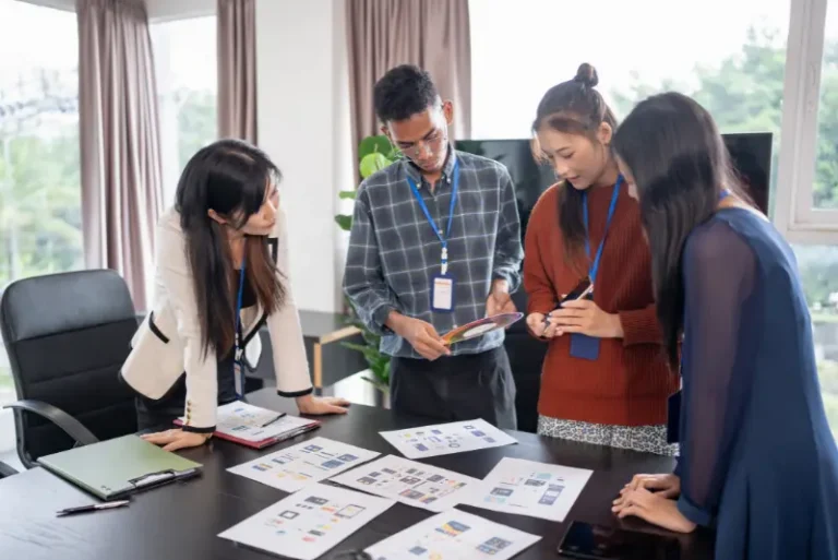 Team collaborating on a laptop to manage brand presence across social media channels